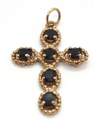 Lot 109 - A 9ct sapphire cross, the dark blue sapphires...