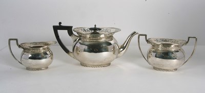 Lot 255 - A George V silver tea set of compressed oval...