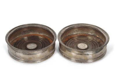 Lot 258 - A pair of George III silver coasters having...