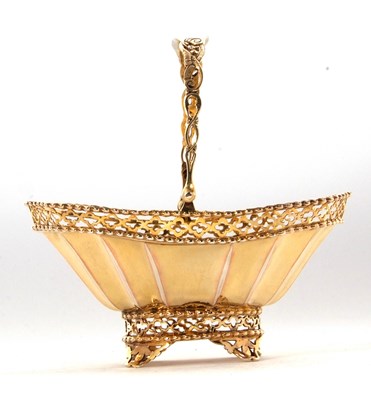 Lot 260 - A George V silver-gilt bonbon basket having a...