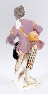 Lot 15 - A Meissen figure of a gallant holding a posie...