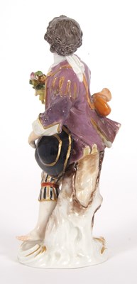Lot 15 - A Meissen figure of a gallant holding a posie...