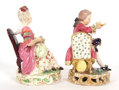 Lot 16 - A pair of Derby figures both seated on chairs...