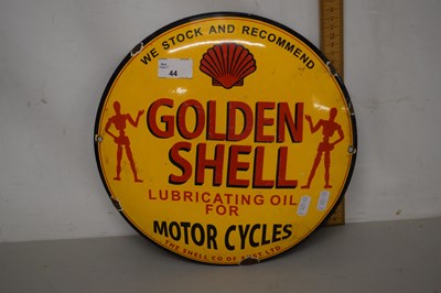 Lot 44 - A circular enamel sign marked Golden Shell...