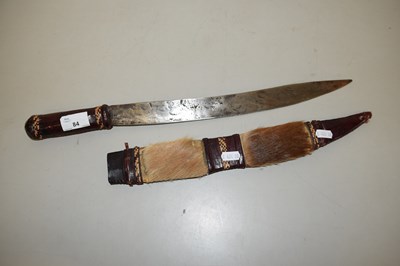 Lot 84 - An ethnic knife in hide covered case