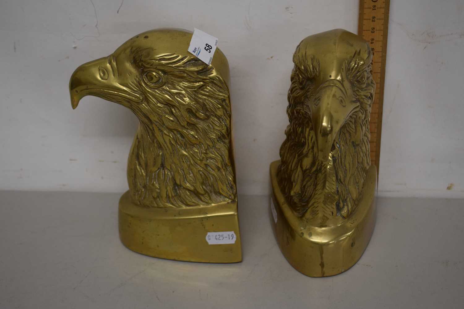 Lot 58 - Pair of brass eagles head bookends or doorstops