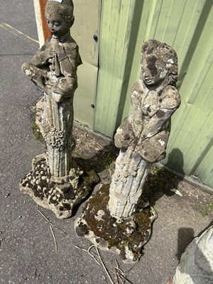 Lot 1124 - Two composite garden statues of a boy and girl