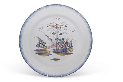 Lot 49 - An 18th Century Delft charger with polychrome...