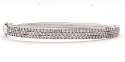 Lot 362 - An 18ct diamond bangle, the white gold hinged...