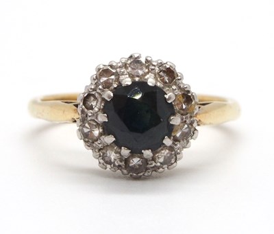 Lot 27 - A sapphire and diamond ring, the round...