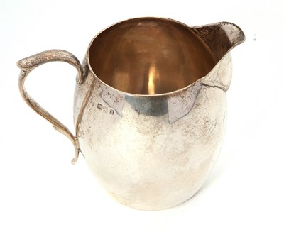 Lot 2 - A George V silver cream jug of bulbous...