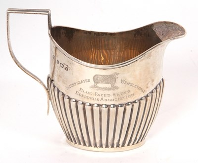 Lot 12 - An early 20th Century silver cream jug of oval...
