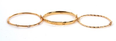 Lot 133 - Two 9ct bangles and another: to include a 9ct...