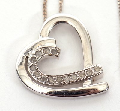 Lot 202 - A 9K white gold and diamond heart necklace,...