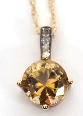 Lot 213 - A 9ct diamond and yellow-brown treated quartz...