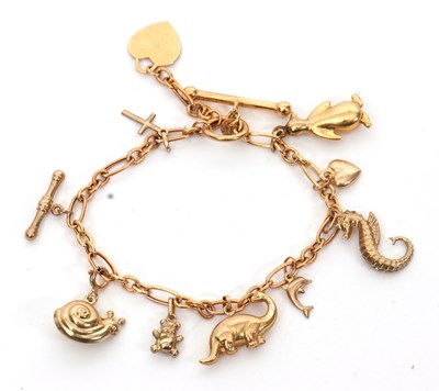 Lot 253 - A 9ct charm bracelet, the bracelet with tag...