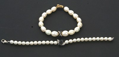 Lot 322 - Two cultured pearl and diamond bracelets: to...