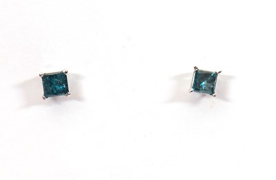 Lot 193 - A pair of 14k treated blue diamond earstuds,...