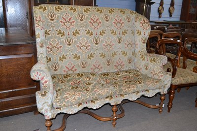 Lot 513 - A Carolean style wing back sofa with floral...