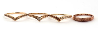 Lot 106 - Three 9ct wishbone rings and a 9K ring: to...