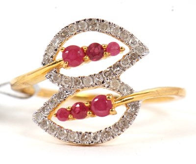 Lot 89 - A 9ct ruby and diamond ring, the two crossover...