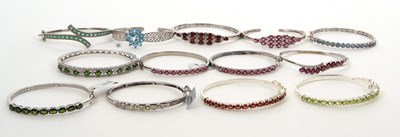 Lot 410 - Thirteen silver and gemset bangles, to include...