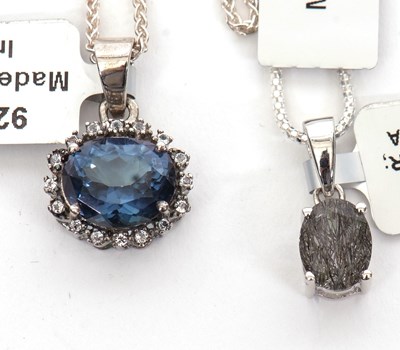 Lot 378 - Two gemset pendants: to include an oval...