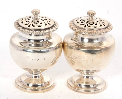 Lot 115 - A pair of Georgian silver pounce pots, marks...