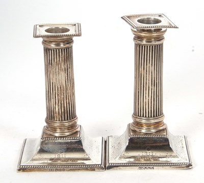 Lot 136 - A pair of small Edwardian candlesticks having...