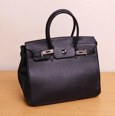 Lot 139 - A lady's black leather handbag, with chrome...