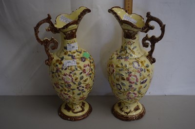 Lot 24 - Pair of floral decorated ewers
