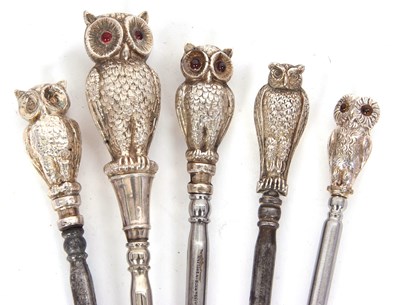 Lot 223 - Five silver mounted "owl" button hooks to...