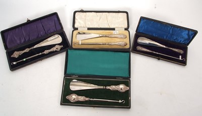 Lot 330 - Four cased silver handled matching shoe horn...