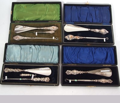 Lot 335 - Four cased silver handled button hook and shoe...