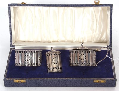 Lot 351 - A cased three piece cruet set of oval form,...