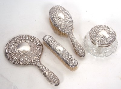 Lot 354 - A four piece silver backed/topped dressing...