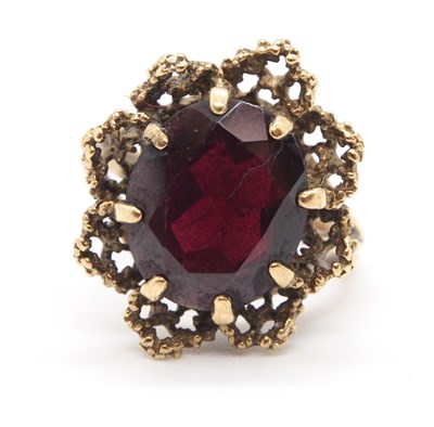 Lot 64 - A 9ct garnet ring, the claw mounted oval...