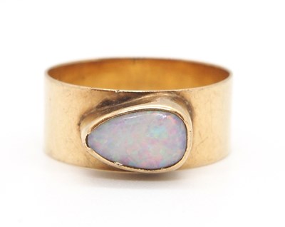 Lot 65 - An opal ring, the pear shape opal cabochon,...