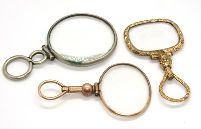 Lot 181 - A repousse gilt metal framed magnifier, an...