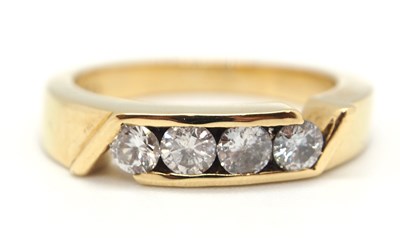 Lot 52 - A diamond ring, set with four round brilliant...