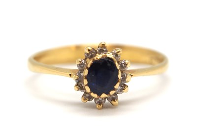 Lot 49 - A sapphire and diamond cluster ring, the...