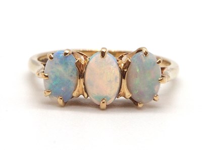 Lot 72 - A 9ct opal ring, the three oval claw mounted...