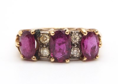 Lot 6 - A ruby and diamond ring, the three oval rubies,...