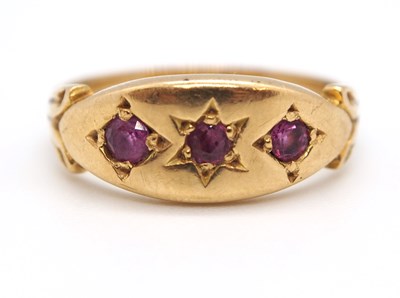 Lot 2 - An 9ct ruby ring, the three round gypsy set...