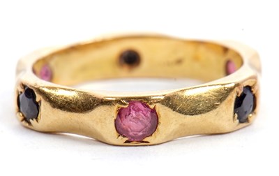 Lot 46 - A sapphire and ruby ring, the 4mm wide band...