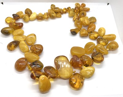 Lot 327 - An amber bead necklace, comprised of irregular...