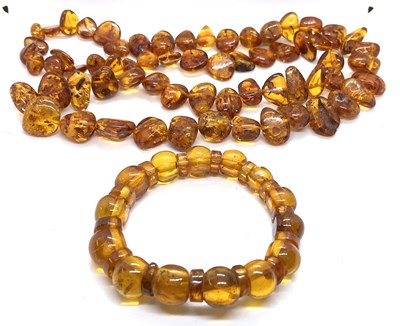 Lot 190 - An amber necklace and bracelet, the necklace...