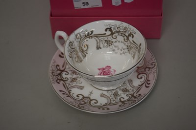 Lot 59 - A cased Althorp rose decorated tea cup and saucer