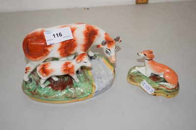 Lot 116 - Staffordshire style model of a cow and calf...