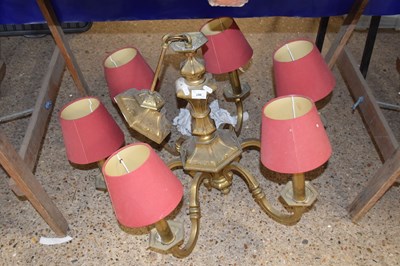 Lot 244 - Brass six branch light fitting with red shades